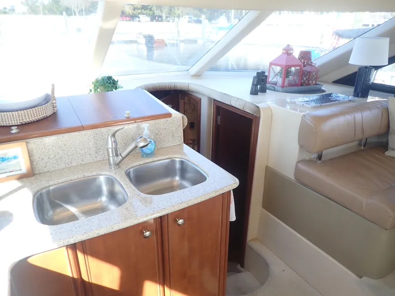 Slide: The Image of Interior of 2006 Meridian 411 Sedan yacht with kitchen sink and seating area. - 15