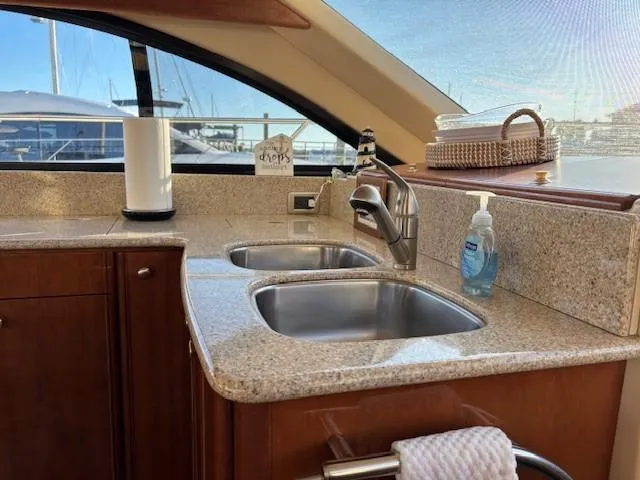 Slide: The Image of Luxury yacht kitchen with dual sinks, granite countertops, and marina view; Meridian 411 Sedan, 2006. - 17