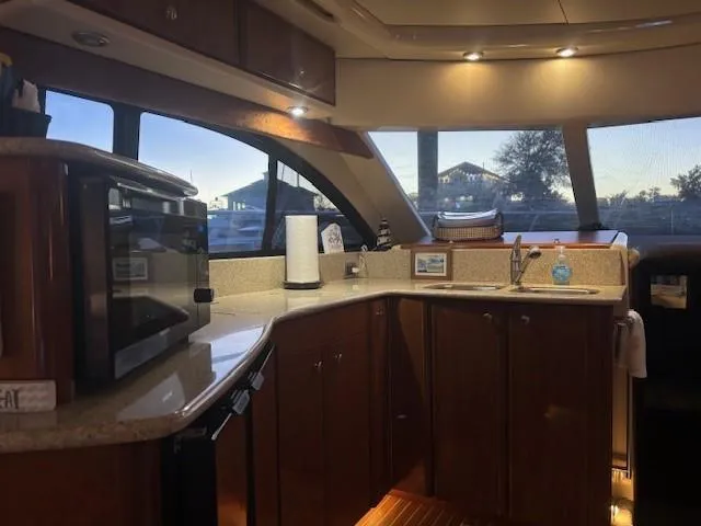 Slide: The Image of Interior of 2006 Meridian 411 Sedan yacht kitchen with wood cabinets and modern appliances. - 18