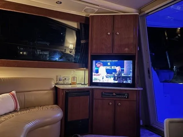 Slide: The Image of Interior of 2006 Meridian 411 Sedan yacht with TV, leather seating, and ambient lighting. - 20