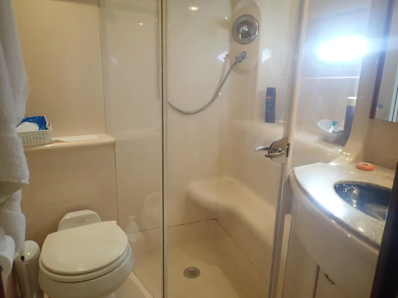 Slide: The Image of Bathroom interior of 2006 Meridian 411 Sedan yacht, featuring shower and toilet. - 25