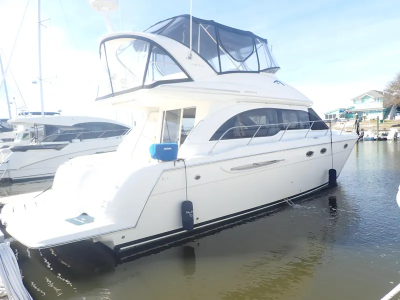 Slide: The Image of 2006 Meridian 411 Sedan yacht docked in marina, featuring sleek design and spacious upper deck. - 3