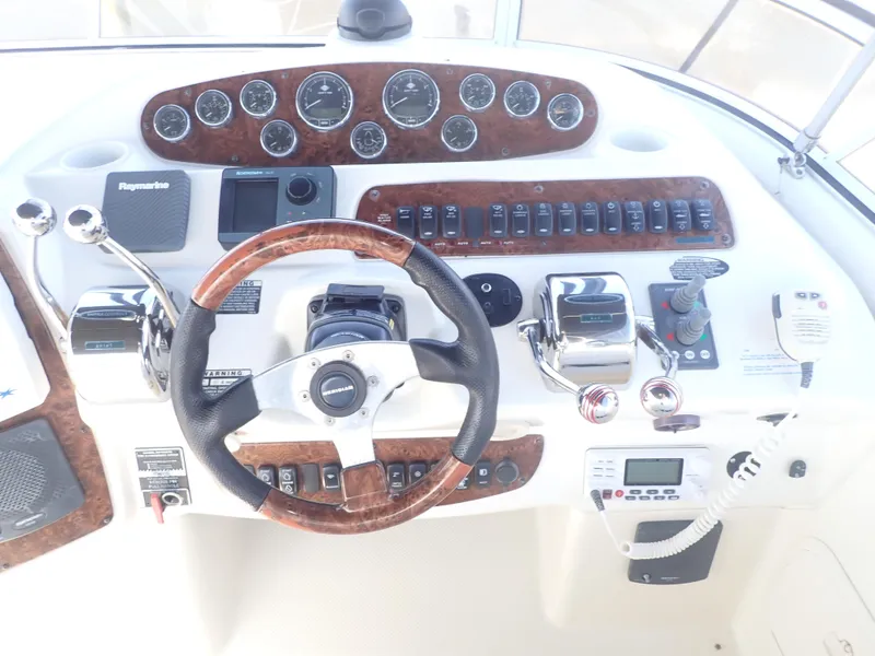 Slide: The Image of Cockpit of 2006 Meridian 411 Sedan with steering wheel, gauges, and controls. - 32