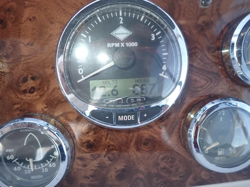 Slide: The Image of Dashboard gauges of a 2006 Meridian 411 Sedan boat, featuring RPM and voltage indicators. - 37