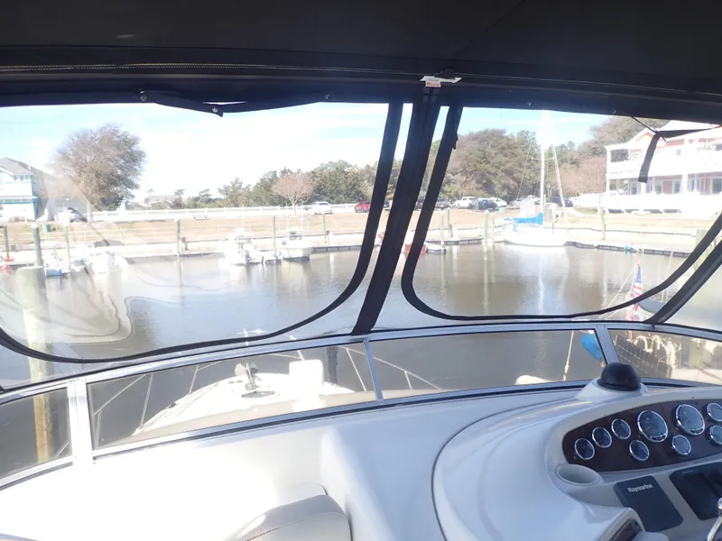 Slide: The Image of View from the helm of a 2006 Meridian 411 Sedan yacht in a marina. - 38