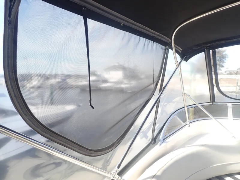 Slide: The Image of 2006 Meridian 411 Sedan boat with mesh window cover and metal frame. - 39