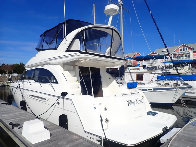 Slide: The Image of 2006 Meridian 411 Sedan yacht docked at marina under clear blue sky. - 4