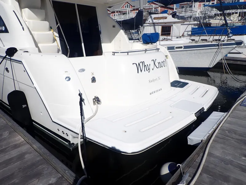 Slide: The Image of 2006 Meridian 411 Sedan yacht docked, featuring "Why Knot" on the stern. - 42