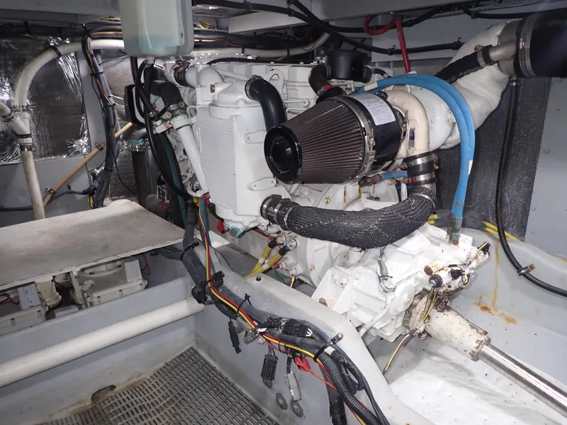 Slide: The Image of Engine room of a 2006 Meridian 411 Sedan boat, showcasing mechanical components and wiring. - 44