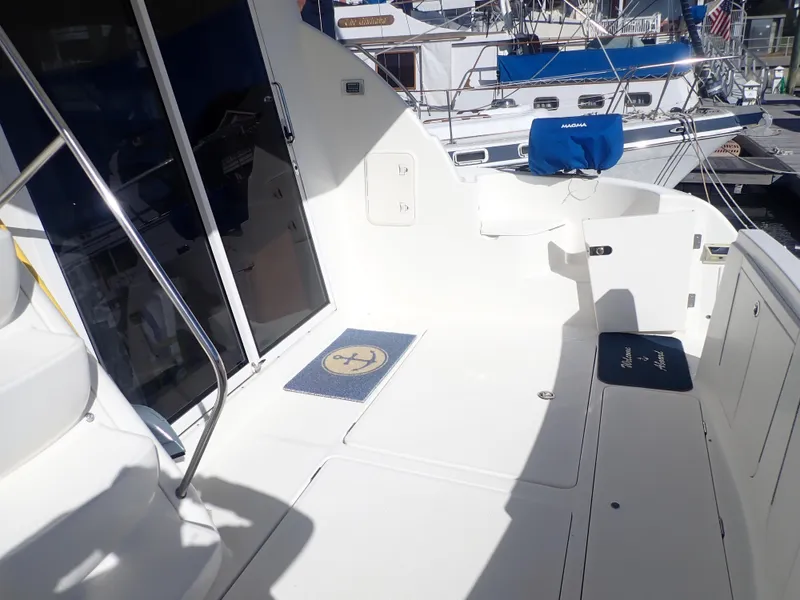 Slide: The Image of 2006 Meridian 411 Sedan yacht deck with seating and nautical decor. - 5