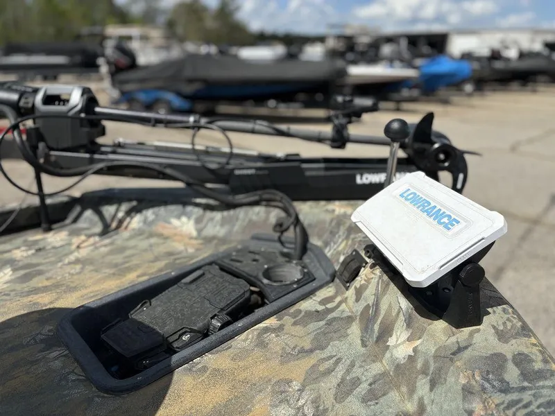 Slide: The Image of 2015 Ranger RC188 boat with Lowrance equipment and camouflage design in a marina setting. - 10