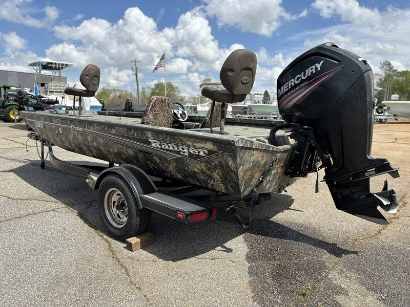 Slide: The Image of 2015 Ranger RC188 boat with Mercury outboard motor on trailer, parked outdoors. - 13