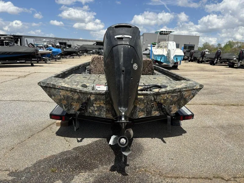 Slide: The Image of Ranger RC188 2015 boat with camouflage design, parked outdoors under a cloudy sky. - 15