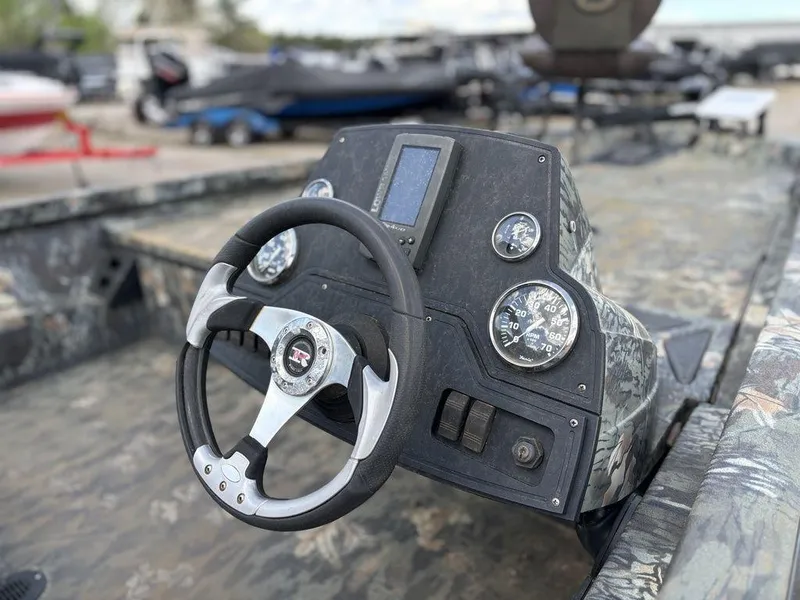 Slide: The Image of Steering console of a 2015 Ranger RC188 boat, featuring gauges and a digital display. - 8