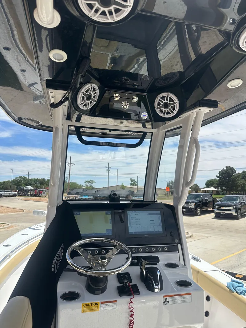 Slide: The Image of 2023 Sportsman Masters 247OE Bay Boat dashboard with steering wheel and electronic controls. - 11