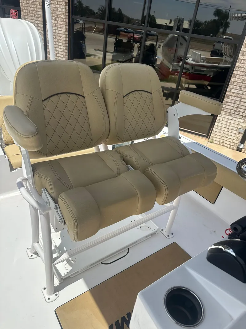 Slide: The Image of 2023 Sportsman Masters 247OE Bay Boat with tan cushioned seating and armrests. - 15