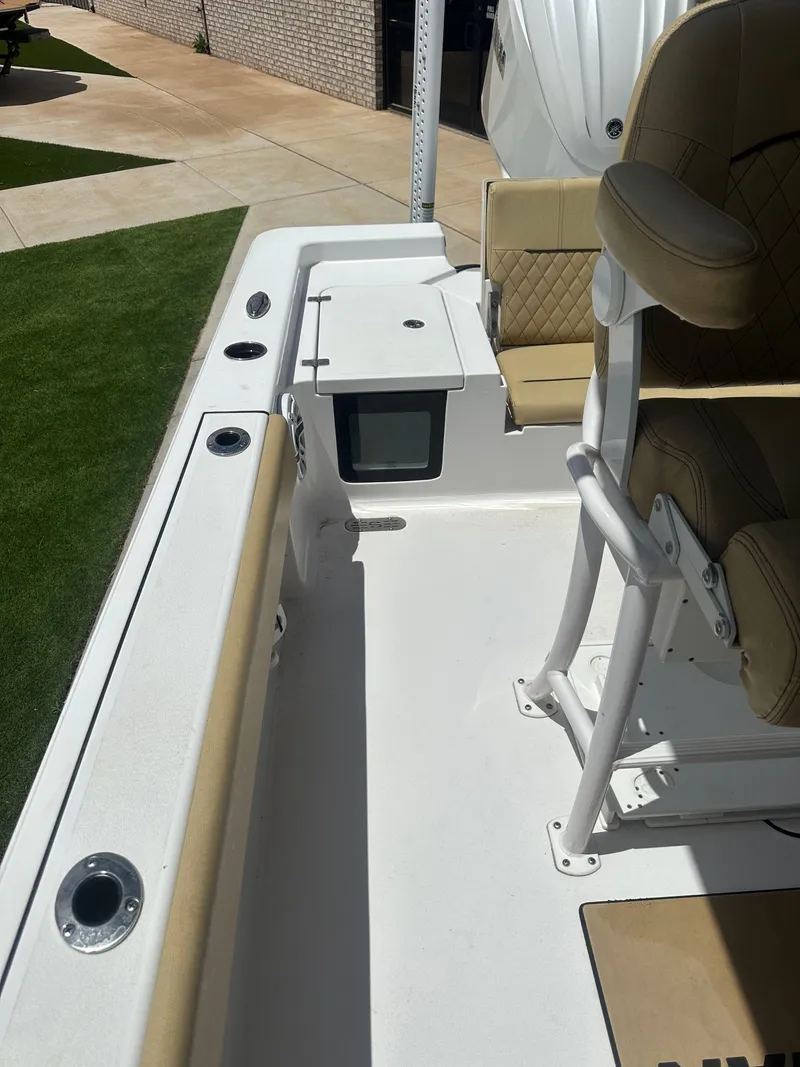 Slide: The Image of 2023 Sportsman Masters 247OE Bay Boat interior with seating and storage features. - 16