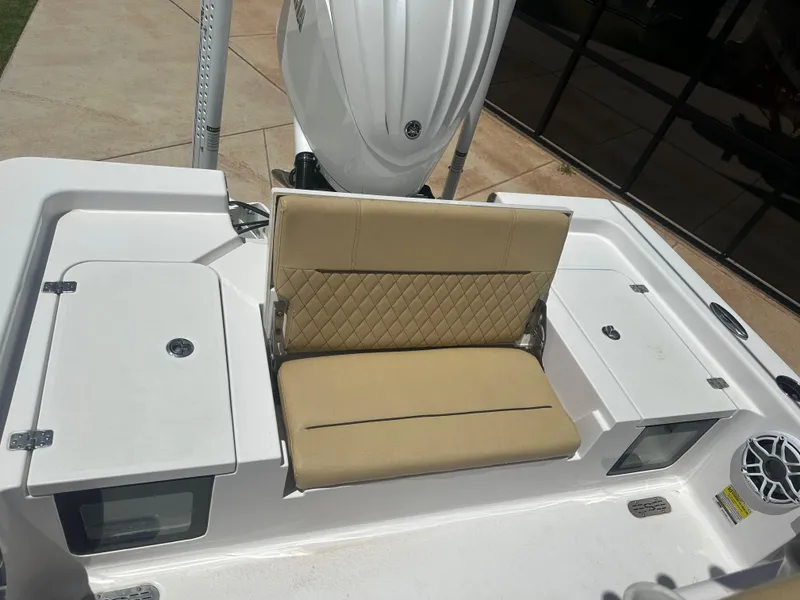 Slide: The Image of 2023 Sportsman Masters 247OE Bay Boat with beige seating and storage compartments. - 17