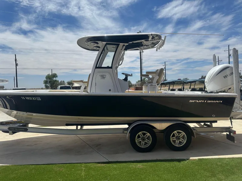 Slide: The Image of 2023 Sportsman Masters 247OE Bay Boat on trailer, side view under clear sky. - 4
