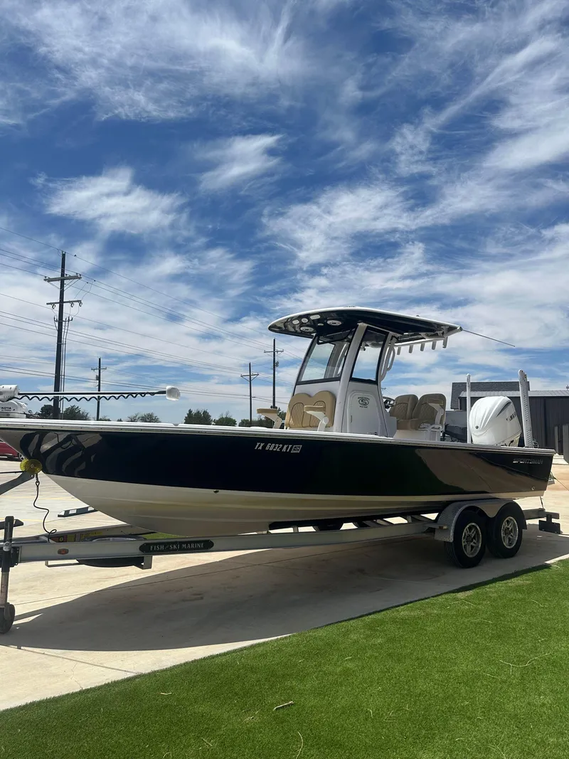 Slide: The Image of 2023 Sportsman Masters 247OE Bay Boat on trailer under blue sky. - 5