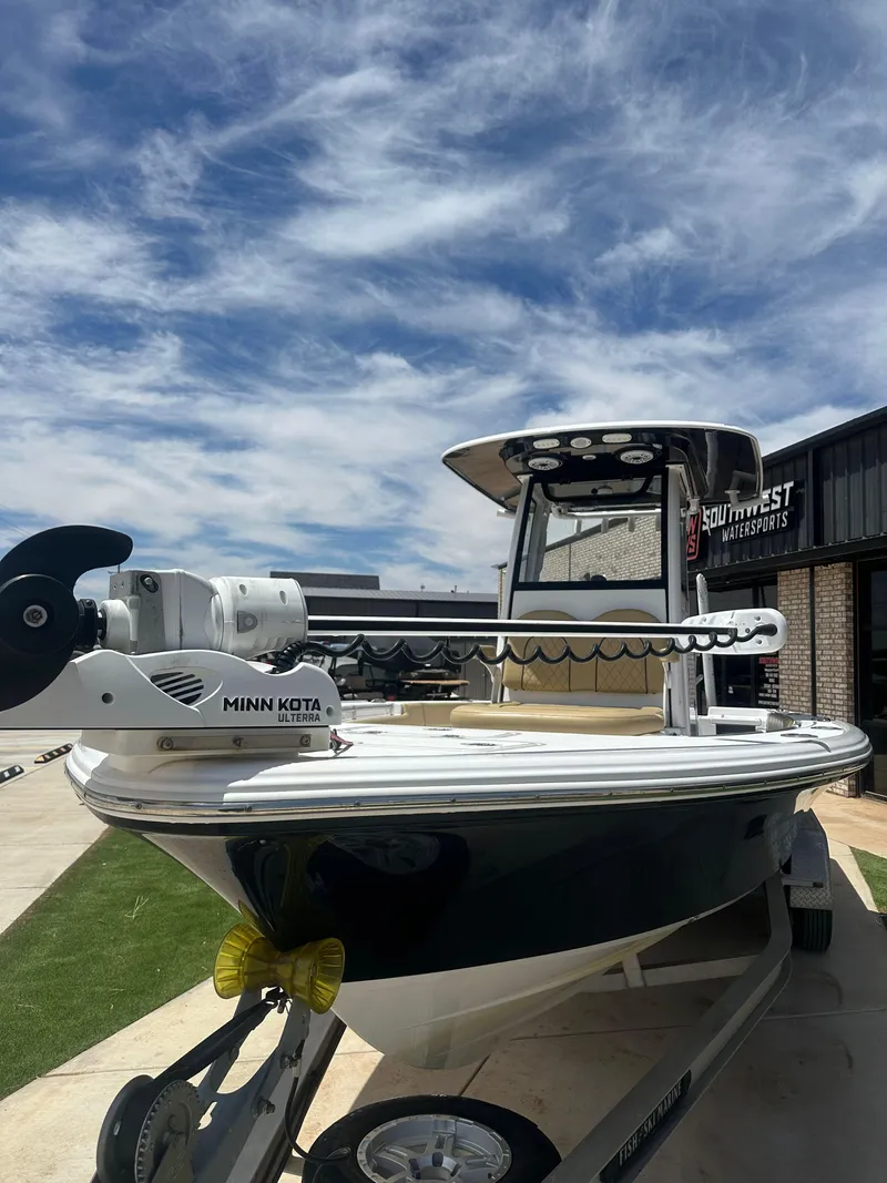 Slide: The Image of 2023 Sportsman Masters 247OE Bay Boat with Minn Kota motor under a cloudy sky. - 6