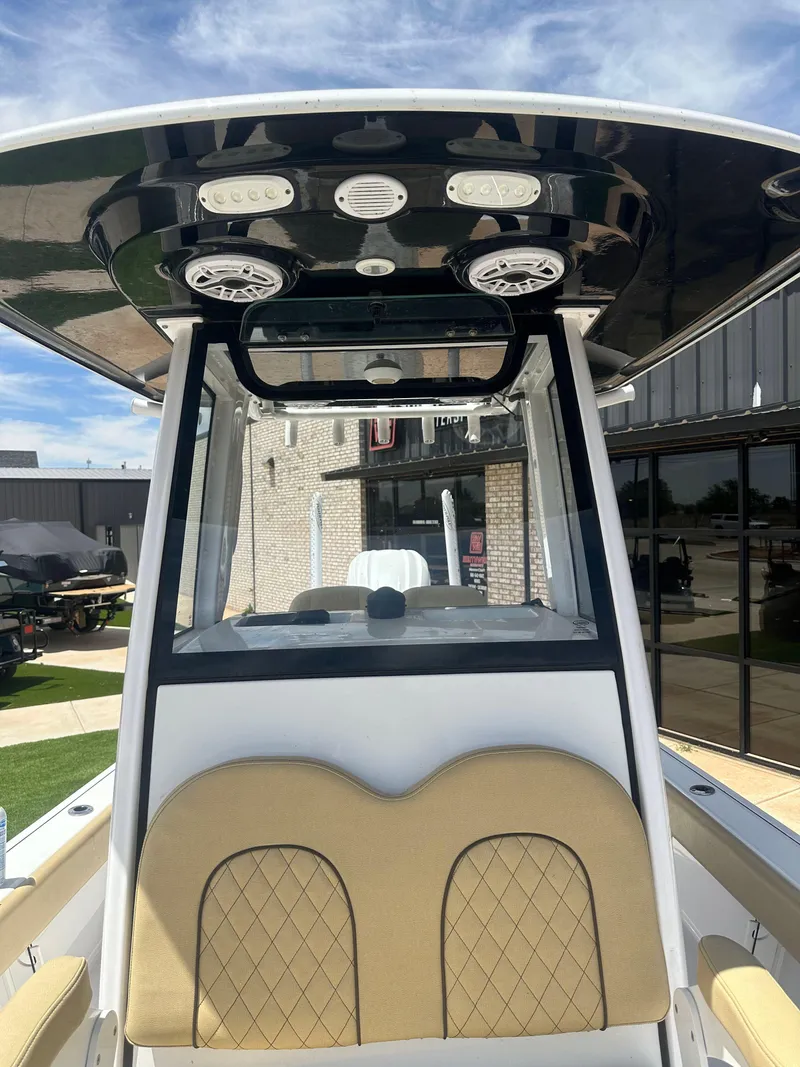 Slide: The Image of 2023 Sportsman Masters 247OE Bay Boat interior with tan seating and modern console design. - 8