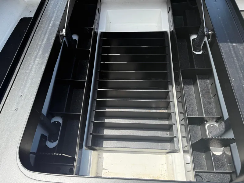 Slide: The Image of 2023 Skeeter ZXR 20 boat storage compartment with organized shelving and sleek design. - 15