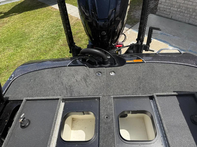 Slide: The Image of 2023 Skeeter ZXR 20 boat deck with storage compartments and motor, viewed from above. - 16
