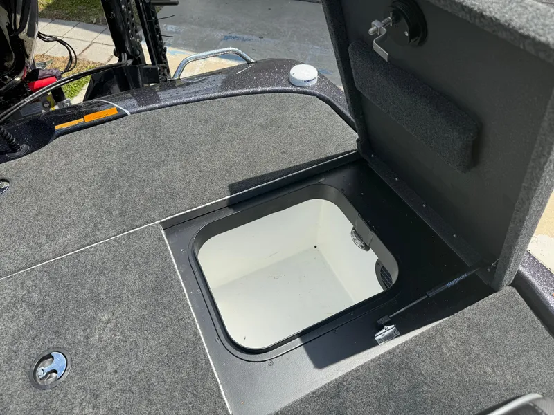 Slide: The Image of 2023 Skeeter ZXR 20 boat storage compartment with open hatch, showcasing interior space. - 17