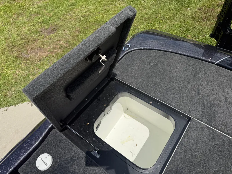 Slide: The Image of Open storage compartment on 2023 Skeeter ZXR 20 boat, showing interior and latch mechanism. - 18