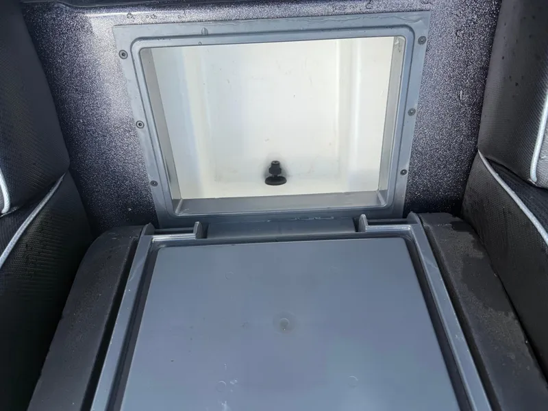 Slide: The Image of 2023 Skeeter ZXR 20 boat storage compartment with open lid, showcasing interior space. - 19