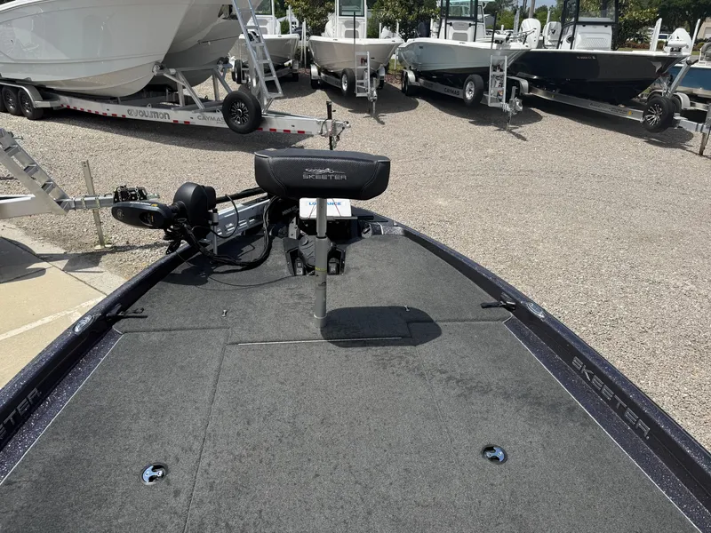 Slide: The Image of 2023 Skeeter ZXR 20 boat deck with seating and motor, displayed outdoors. - 20