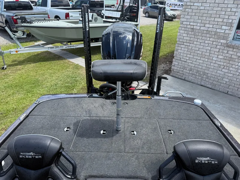 Slide: The Image of 2023 Skeeter ZXR 20 boat interior with seating and motor, displayed outdoors. - 21