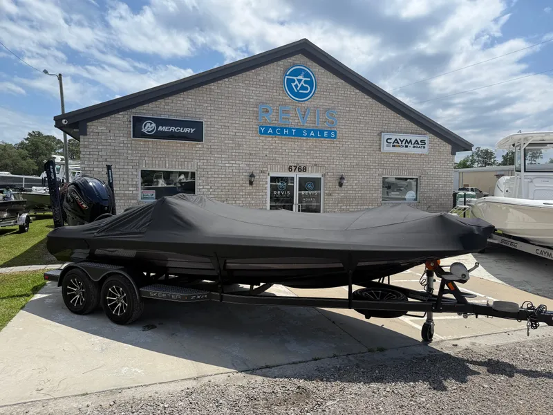 Slide: The Image of 2023 Skeeter ZXR 20 boat covered, parked outside Reeves Yacht Sales building. - 26