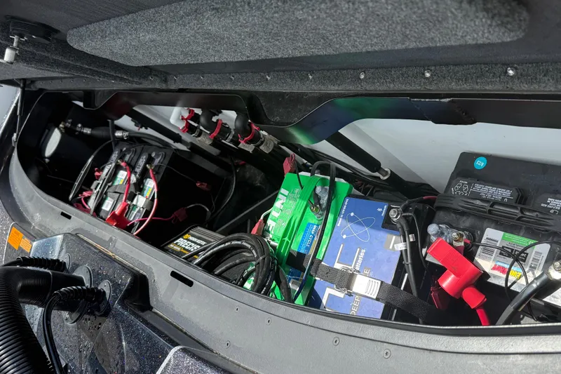 Slide: The Image of 2023 Skeeter ZXR 20 boat battery compartment with multiple batteries and wiring. - 30