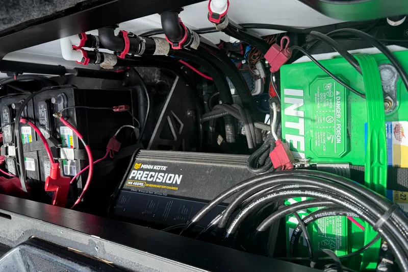 Slide: The Image of 2023 Skeeter ZXR 20 boat battery compartment with wiring and Minn Kota Precision charger. - 31