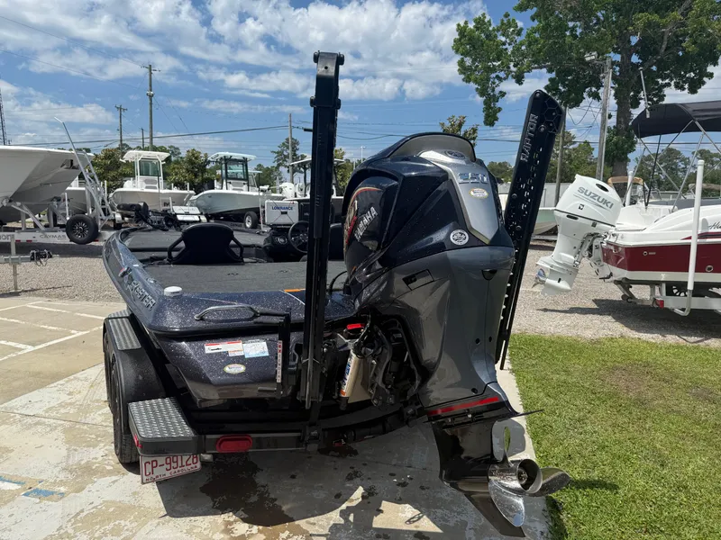 Slide: The Image of 2023 Skeeter ZXR 20 boat with powerful outboard motor, parked outdoors on a sunny day. - 9