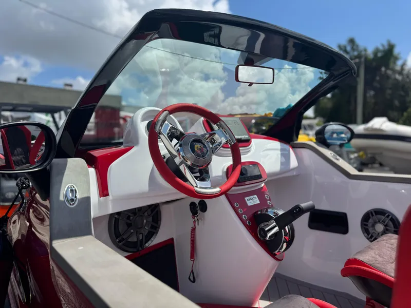 Slide: The Image of Interior of 2025 Car Off-shore Fiat 500 Abarth boat with red accents and steering wheel. - 4