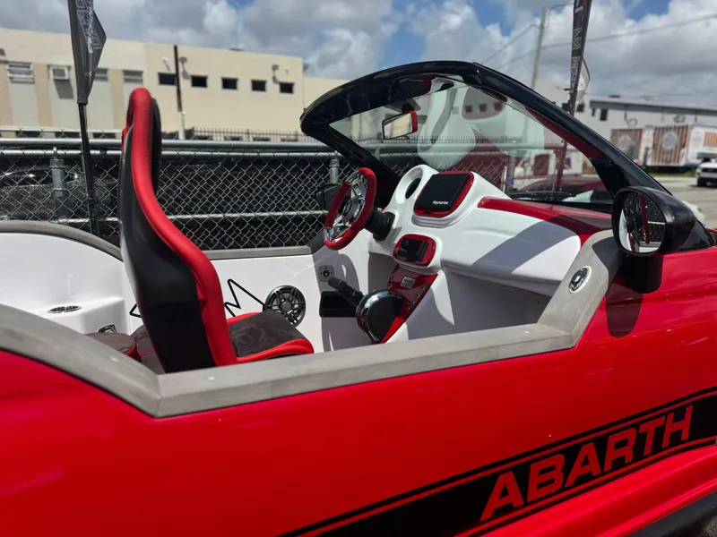 Slide: The Image of 2025 Car Off-shore Fiat 500 Abarth interior, red and white design, sporty steering wheel. - 3