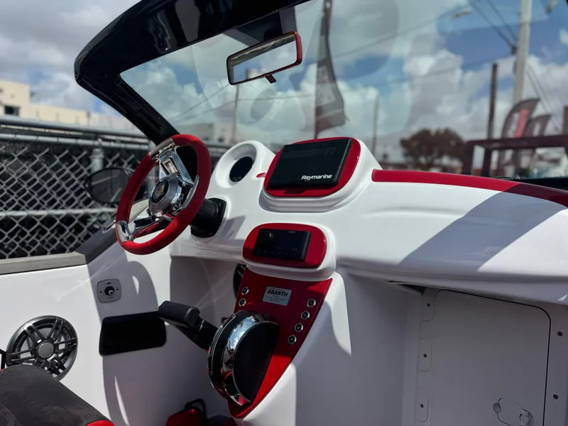 Slide: The Image of Interior of 2025 Car Off-shore Fiat 500 Abarth with red accents and modern dashboard. - 5