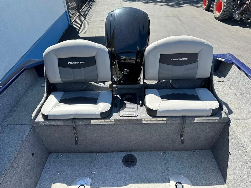 Slide: The Image of 2019 Tracker Pro Guide V-175 Combo boat seats and motor, outdoor setting. - 17