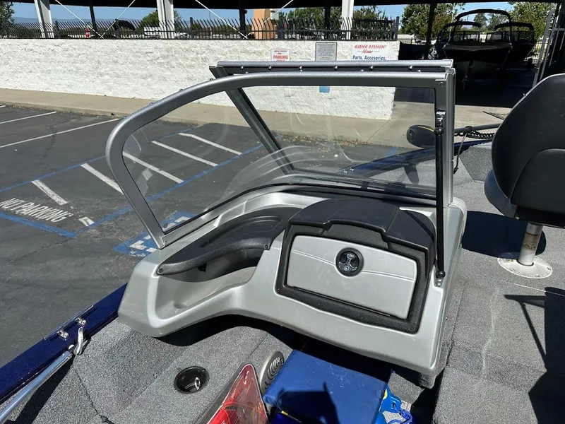 Slide: The Image of 2019 Tracker Pro Guide V-175 Combo boat dashboard with windshield in a parking lot. - 21