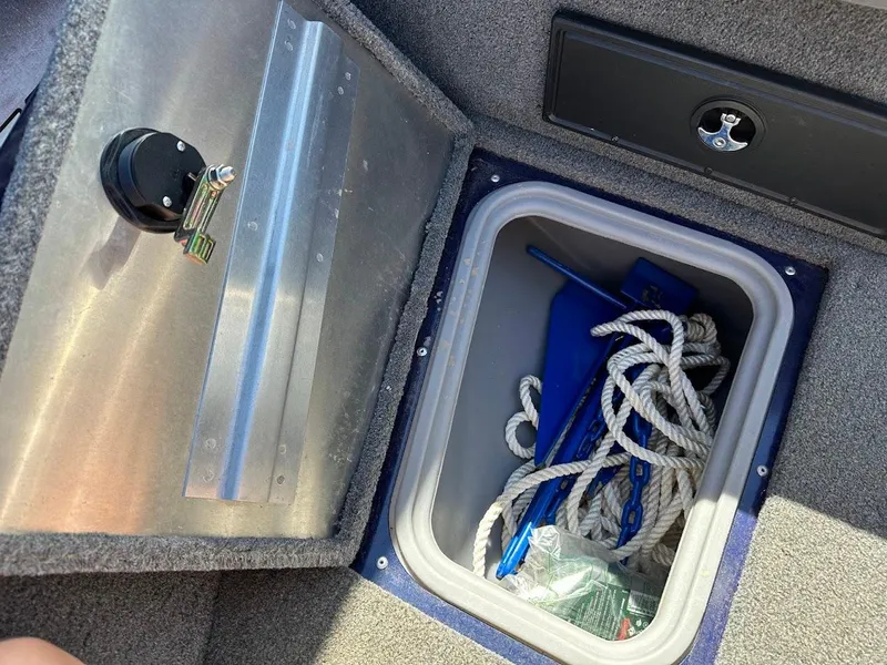 Slide: The Image of Storage compartment in 2019 Tracker Pro Guide V-175 Combo boat with rope and anchor. - 36