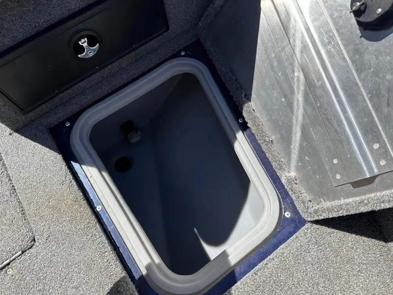 Slide: The Image of 2019 Tracker Pro Guide V-175 Combo boat storage compartment, open lid, gray interior. - 37