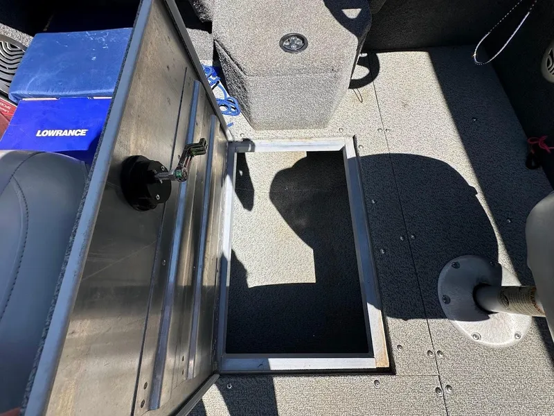 Slide: The Image of 2019 Tracker Pro Guide V-175 Combo boat interior with open storage compartment and Lowrance equipment. - 38