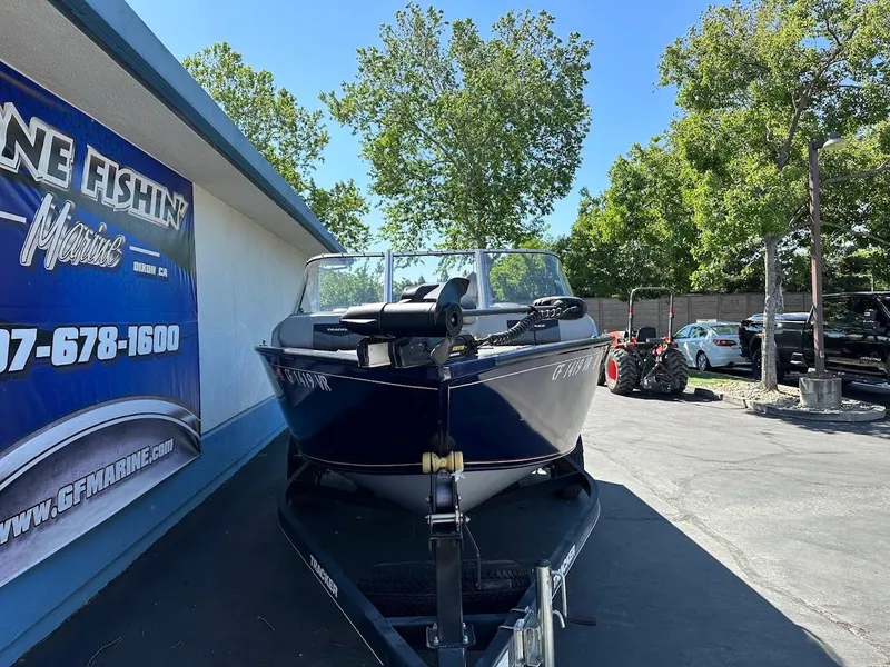 Slide: The Image of 2019 Tracker Pro Guide V-175 Combo boat on trailer, parked outdoors near a marine shop. - 4