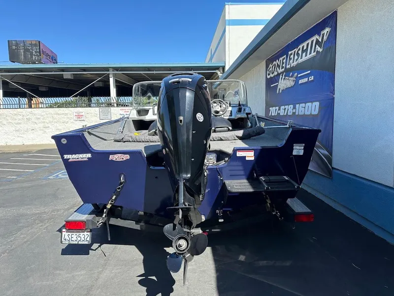 Slide: The Image of 2019 Tracker Pro Guide V-175 Combo boat, parked outdoors, rear view with motor. - 7