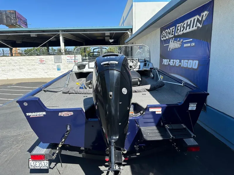 Slide: The Image of 2019 Tracker Pro Guide V-175 Combo boat, parked outside a fishing store. - 8