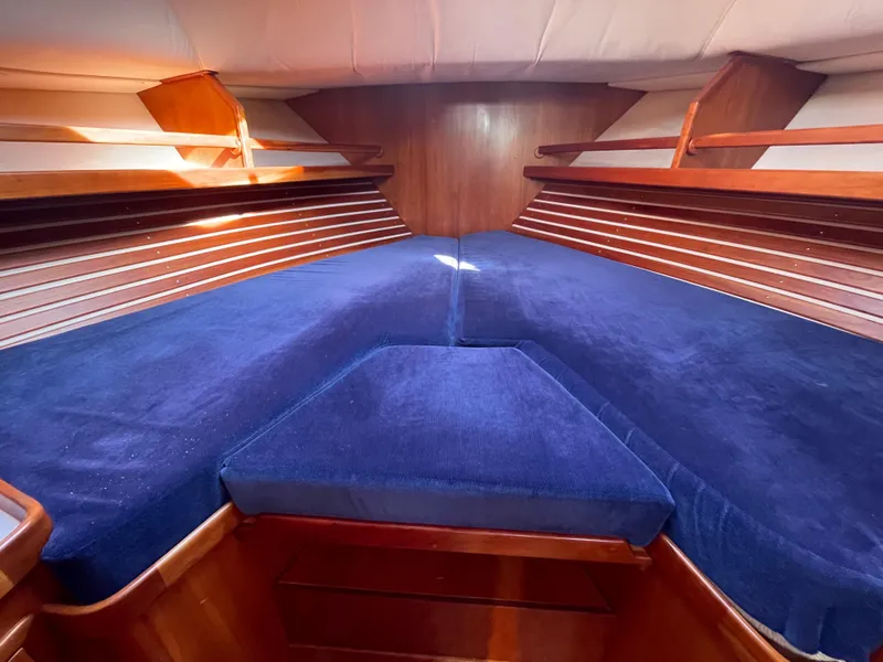Slide: The Image of Interior cabin of 1997 Little Harbor WhisperJet 36 with blue cushions and wooden accents. - 13