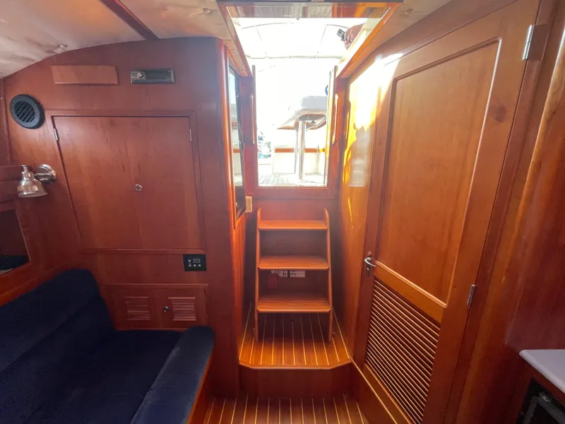 Slide: The Image of Interior of 1997 Little Harbor WhisperJet 36, featuring wooden cabinetry and seating. - 14